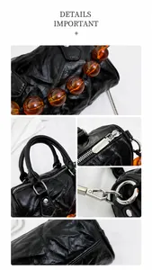 Detalle del bolso Boston de cuero plisado negro con cadena de ámbar y herrajes de plata