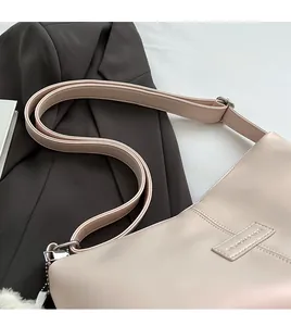 Detail of adjustable strap and silver hardware on a cream minimalist tote bag