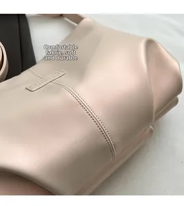 Close-up of soft pearlescent leather texture with durable stitching on tote bag