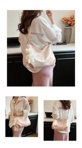 Close-up of pale pink cloud tote bag with adjustable strap and cute white bear pendant