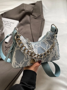 Light blue crescent armpit bag with white floral lace overlay and silver chain detail
