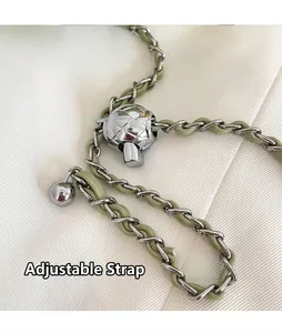 Detail of adjustable chain strap with a silver ball slider on a green leather handbag