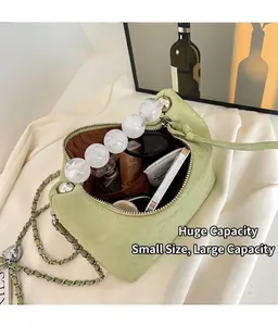 Detail view of a green beaded handbag interior showing large storage capacity for cosmetics