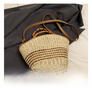 Detailed shot of retro straw tote bag with bamboo handle and dual-color woven texture