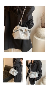 Detailed views of a silver cloud bag with butterfly clasp and metal chain strap