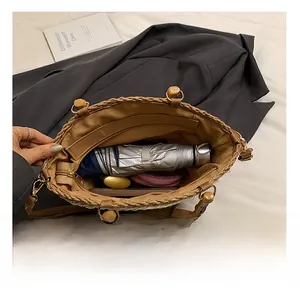 Top view of spacious straw bucket bag showing large capacity for umbrella and phone