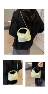 Detail view of mint green ruched handle and golden chain on fashion shoulder bag
