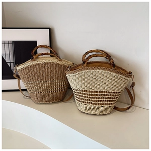 Detail of hand-woven straw bucket bags with retro bamboo handles and leather straps