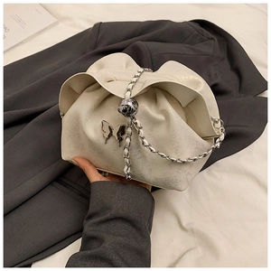 Detail of white pleated cloud bag with silver butterfly charm and chain strap