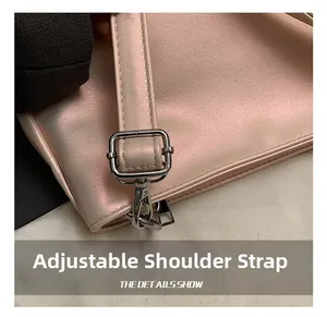 Close-up of pink ballet-style bag featuring adjustable silver buckle and fine stitching