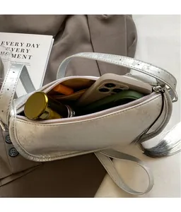Interior view of silver cylindrical bag showing ample space for phone and lipstick