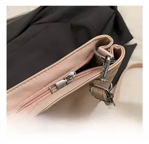 Detail of premium silver-tone metal zipper and hook hardware on ballet-style bag