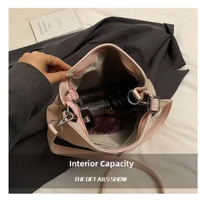 Internal capacity of pink ballet style crossbody bag showing cosmetics and lining