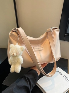 Minimalist beige PU leather tote bag for women with cute teddy bear charm and wide strap