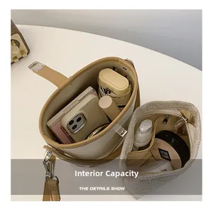 Interior view of the cream bucket bag showing high capacity for phone and umbrella