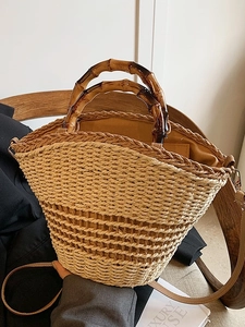 Woven straw bucket bag with bamboo handle and leather strap for a vintage French summer look