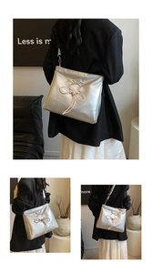 Detail of silver balletcore shoulder bag with pink lace-up bow and metallic finish