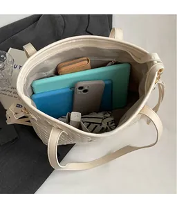 Interior view of cream woven tote bag showing large capacity for tablet and daily items