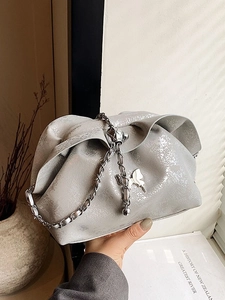 Chic silver pleated cloud bag with butterfly chain strap and glossy metallic texture