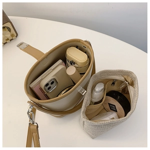 Detail view of the bucket bag interior showing spacious storage for a phone and umbrella