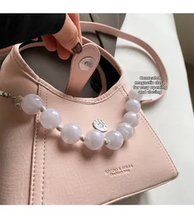 Detail of pink beaded handbag featuring a hidden magnetic clasp for easy opening