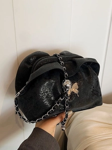 Fashionable black pleated cloud bag with silver butterfly chain strap and crinkle texture