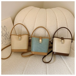 Detailed trio of stylish bucket bags showing lock clasps and adjustable straps