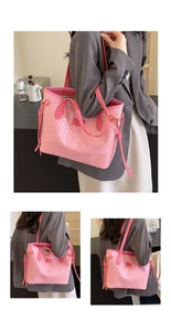 Detail shot of the pink woven leather texture and elegant golden hardware on large tote bag
