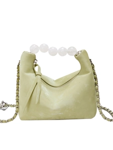 Light green faux leather handbag with white beaded handle and woven chain strap