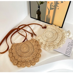 Detail of bohemian hollow out crochet shoulder bags with faux leather straps