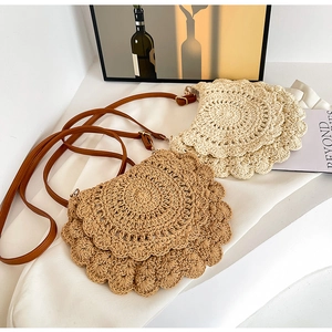 Detailed macro view of woven layered petal texture on straw crochet shoulder bags
