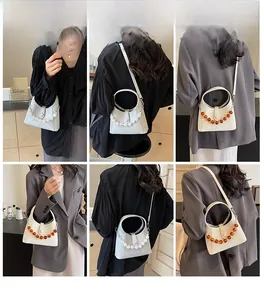 Detail shots of women's minimalist crossbody bag with elegant bead handles and shoulder strap