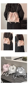 Chic drawstring bucket bags in pink and silver with elegant metal bow detail