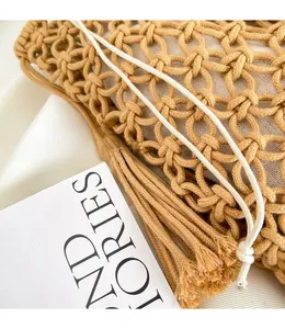 Detailed macro view of the linen woven hollow texture and decorative tassel on the bag