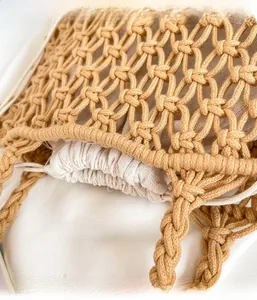 Detail of hand-woven mesh bag with drawstring canvas inner pouch for beach holidays