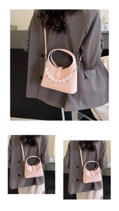 Detail of pink beaded handbag showing faux pearl chain and fine synthetic leather texture