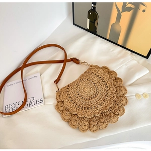 Detail of khaki crochet crossbody bag featuring layered wave edges and leather strap