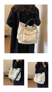 Detail view of canvas tote bag with multiple pockets and contrasting green straps