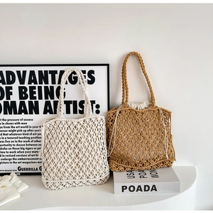 Detailed close-up of woven tote bags in beige and caramel with drawstring inner linings