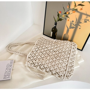 Detailed view of the handcrafted crochet macrame tote bag with decorative fringe and tassels