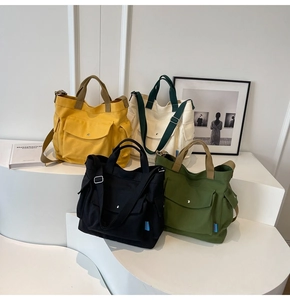 Detail of canvas tote bags in four colors with adjustable straps and side pockets