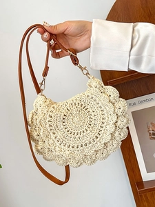 Chic cream woven shoulder bag with layered petal design and adjustable leather strap