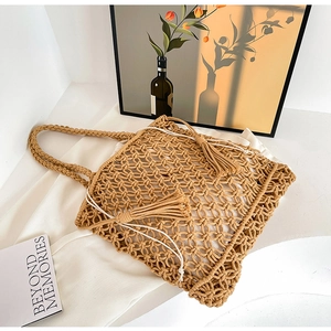 Detail of hollow woven tote with khaki rope texture, white inner pouch, and fringe accents