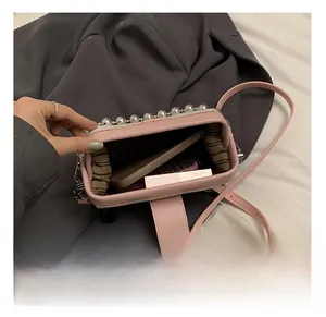 Detailed interior view of a pink butterfly crossbody bag showing storage capacity
