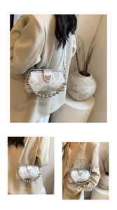 Detail of butterfly embroidery bag with silver metal ball chain and buckle