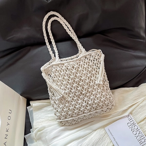 Bohemian off-white hollow woven shoulder bag with tassels and internal cloth pouch