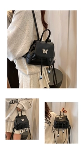 Detail eines schwarzen PU-Lederrucksacks mit silbernem 3D-Metallschmetterling und Kordelzug