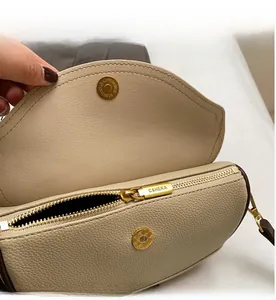 Detail of the textured pebble leather interior, smooth gold zipper, and magnetic closure