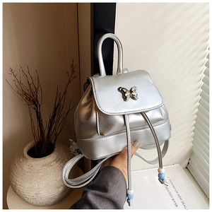 Details des silbernen Metallic-Rucksacks mit elegantem Schmetterlingsverschluss