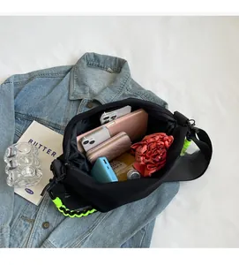 Internal view of black nylon crossbody bag showing large capacity storage and items